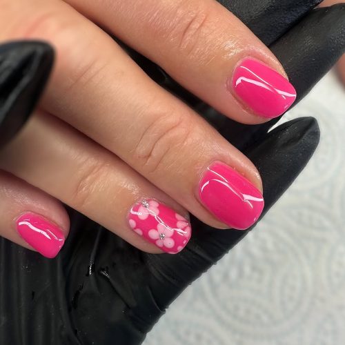 23-Vibrant Pink Nails with Floral Detailing